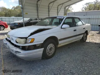 1992 Ford Taurus GL with VIN 1FALP52U5NA280821, listed as a Copart auction lot 77457304 with 33,484 mi miles and Salvage Title. Bid and sale history available at carsss.com. Image 1.
