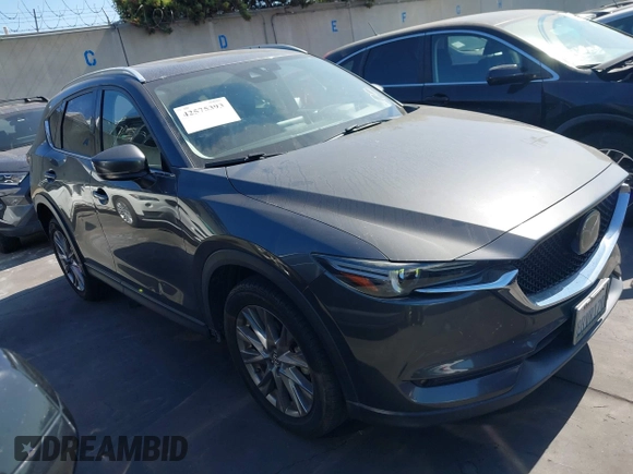 2020 Mazda CX-5 Grand Touring with VIN JM3KFADM3L1812649, listed as a IAAI auction lot 42575393 with 102,118 mi miles and . Bid and sale history available at DreamBid. Image 1.