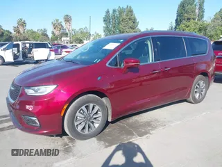 2021 Chrysler Pacifica Hybrid Touring L with VIN 2C4RC1L76MR581285, listed as a IAAI auction lot 42303222 with 77,808 mi miles and . Bid and sale history available at DreamBid. Image 17.