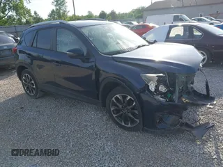 2016 Mazda CX-5 Grand Touring z VIN JM3KE4DY6G0766396, wystawiony jako IAAI lot #42268693 z przebiegiem 101 742 mil mil oraz . Historia ofert i sprzedaży dostępna na DreamBid. Obrazek 1.