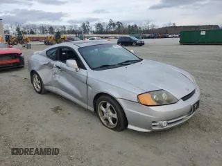 2003 Hyundai Tiburon GT z VIN KMHHN65F63U064962, wystawiony jako Copart lot #44804045 z przebiegiem 186 171 mil mil oraz Szkoda całkowita • Salvage title. Historia ofert i sprzedaży dostępna na DreamBid. Obrazek 4.