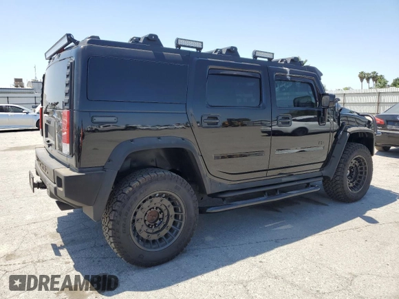 2005 Hummer H2 SUV z VIN 5GRGN23U05H117630, wystawiony jako Copart lot #57087305 z przebiegiem 60 260 mil mil oraz Szkoda całkowita • Salvage title. Historia ofert i sprzedaży dostępna na DreamBid. Obrazek 3.