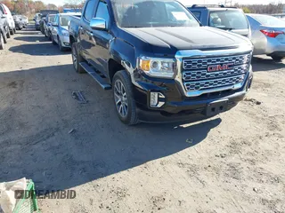 2021 GMC Canyon 4WD Denali z VIN 1GTG6EEN9M1240596, wystawiony jako IAAI lot #40760124 z przebiegiem 52 985 mil mil oraz . Historia ofert i sprzedaży dostępna na DreamBid. Obrazek 1.