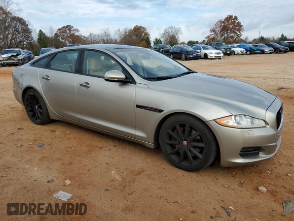 2014 Jaguar XJ with VIN SAJWA1CZ5E8V71971, listed as a Copart auction lot 82116114 with 127,164 mi miles and Salvage Title. Bid and sale history available at DreamBid. Image 4.