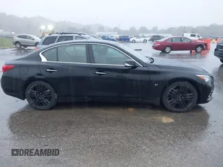 2015 Infiniti Q50 Premium z VIN JN1BV7ARXFM412382, wystawiony jako IAAI lot #40776813 z przebiegiem 66 406 mil mil oraz . Historia ofert i sprzedaży dostępna na DreamBid. Obrazek 13.