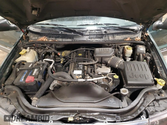 2000 Jeep Grand Cherokee Laredo with VIN 1J4GW48S2YC256123, listed as a Copart auction lot 56015855 with 147,549 mi miles and Salvage title. Bid and sale history available at DreamBid. Image 12.