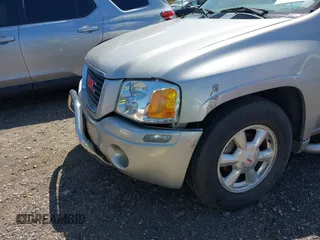 2004 GMC Envoy SLE with VIN 1GKDT13S042113411, listed as a IAAI auction lot 42117824 with 116,827 mi miles. Bid and sale history available at carsss.com. Image 6.