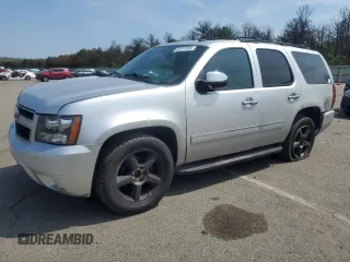 2014 Chevrolet Tahoe LTZ with VIN 1GNSKCE05ER233797, listed as a Copart auction lot 62817395 with 132,609 mi miles and Salvage title. Bid and sale history available at DreamBid. Image 1.