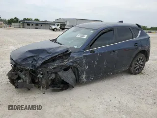 2018 Mazda CX-5 Touring z VIN JM3KFACM9J1466413, wystawiony jako Copart lot #54703055 z przebiegiem 87 038 mil mil oraz Szkoda całkowita • Salvage title. Historia ofert i sprzedaży dostępna na DreamBid. Obrazek 1.