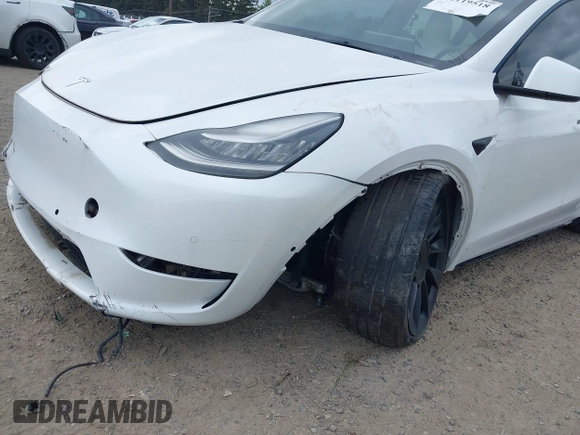 2021 Tesla Model Y Standard Range with VIN 5YJYGDED9MF121828, listed as a IAAI auction lot 42119518 with 34,454 mi miles and . Bid and sale history available at carsss.com. Image 6.