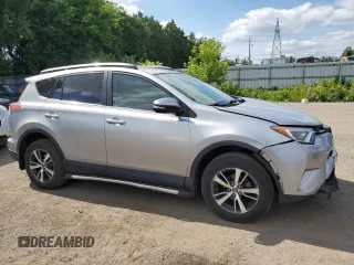 2018 Toyota RAV4 LE with VIN 2T3BFREV8JW788362, listed as a Copart auction lot 64053735 with 124,668 mi miles and Salvage title. Bid and sale history available at DreamBid. Image 4.