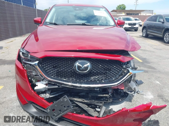 2021 Mazda CX-5 Grand Touring with VIN JM3KFADM6M1373111, listed as a IAAI auction lot 42784431 with 14,374 mi miles and . Bid and sale history available at DreamBid. Image 12.