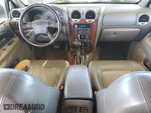 2004 GMC Envoy SLT z VIN 1GKDS13S942127830, wystawiony jako Copart lot #87165024 z przebiegiem 172 592 mil mil oraz Szkoda całkowita • Salvage title. Historia ofert i sprzedaży dostępna na DreamBid. Obrazek 8.
