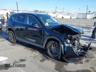 2019 Mazda CX-5 Touring with VIN JM3KFACM7K1534905, listed as a IAAI auction lot 41945607 with 56,014 mi miles. Bid and sale history available at carsss.com. Image 1.