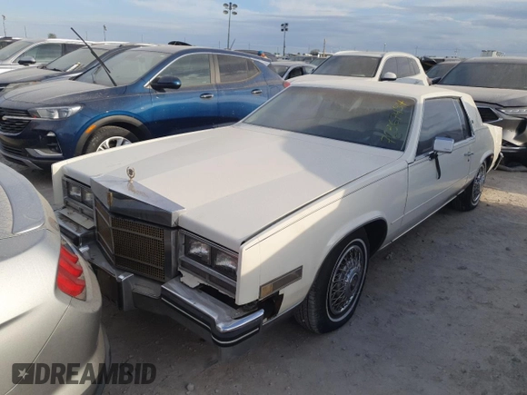 1985 Cadillac Eldorado z VIN 1G6EL5782FE630140, wystawiony jako Copart lot #76367454 z przebiegiem 29 850 mil mil oraz Szkody całkowita. Historia ofert i sprzedaży dostępna na DreamBid. Obrazek 1.