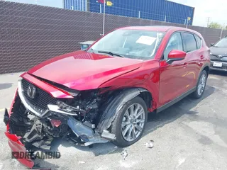 2021 Mazda CX-5 Grand Touring with VIN JM3KFADM6M1373111, listed as a IAAI auction lot 42784431 with 14,374 mi miles and . Bid and sale history available at DreamBid. Image 2.