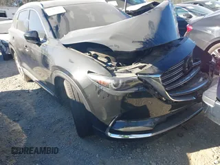 2020 Mazda CX-9 Grand Touring z VIN JM3TCADY8L0405173, wystawiony jako IAAI lot #41701533 z przebiegiem 58 119 mil mil oraz . Historia ofert i sprzedaży dostępna na DreamBid. Obrazek 1.