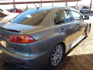 2014 Mitsubishi Lancer Evolution GSR with VIN JA32W8FV3EU008262, listed as a IAAI auction lot 41653902 with 128,977 mi miles. Bid and sale history available at carsss.com. Image 4.
