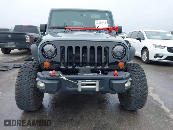 2013 Jeep Wrangler Rubicon 10th Anniversary with VIN 1C4BJWCG2DL651815, listed as a IAAI auction lot 41643919 with 98,297 mi miles and . Bid and sale history available at DreamBid. Image 12.