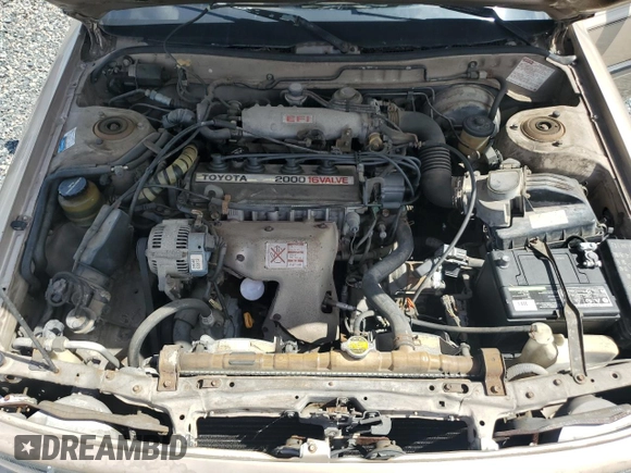 1991 Toyota Camry DLX z VIN 4T1SV21E5MU415356, wystawiony jako Copart lot #74465914 z przebiegiem 74 592 mil mil oraz Szkoda całkowita • Salvage title. Historia ofert i sprzedaży dostępna na DreamBid. Obrazek 11.