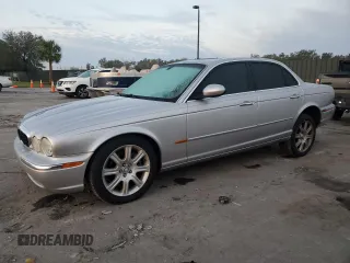 2004 Jaguar XJ with VIN SAJEA71C54SG01326, listed as a Copart auction lot 77449324 with 72,935 mi miles and Salvage Title. Bid and sale history available at carsss.com. Image 1.