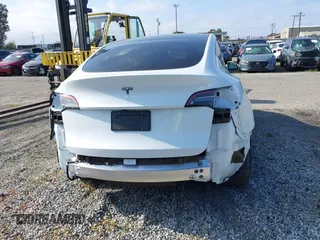 2024 Tesla Model Y with VIN 7SAYGDED2RF017448, listed as a IAAI auction lot 41597056 with 9,702 mi miles and . Bid and sale history available at DreamBid. Image 16.