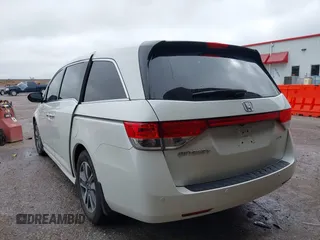2014 Honda Odyssey Touring with VIN 5FNRL5H95EB059729, listed as a IAAI auction lot 42148110 with 135,304 mi miles and . Bid and sale history available at DreamBid. Image 3.