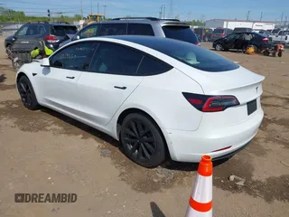 2020 Tesla Model 3 Standard Range Plus with VIN 5YJ3E1EA3LF785951, listed as a IAAI auction lot 41919339 with 63,025 mi miles and . Bid and sale history available at carsss.com. Image 3.