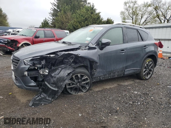 2016 Mazda CX-5 Grand Touring z VIN JM3KE2DY9G0687261, wystawiony jako Copart lot #52865415 z przebiegiem Nie podano mil oraz Szkoda całkowita • Salvage title. Historia ofert i sprzedaży dostępna na DreamBid. Obrazek 1.
