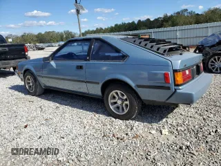 1983 Toyota Celica z VIN JT2RA64L7D6174381, wystawiony jako Copart lot #75986554 z przebiegiem 312 583 mil mil oraz Szkoda całkowita • Salvage title. Historia ofert i sprzedaży dostępna na DreamBid. Obrazek 2.