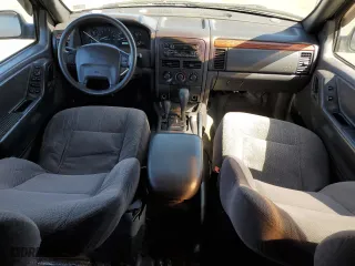 1999 Jeep Grand Cherokee Laredo with VIN 1J4GW58N4XC739465, listed as a Copart auction lot 76130544 with 195,649 mi miles and Salvage Title. Bid and sale history available at carsss.com. Image 8.