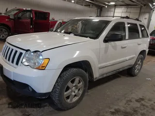 2010 Jeep Grand Cherokee Laredo with VIN 1J4PR4GK7AC126059, listed as a IAAI auction lot 41599058 with 154,192 mi miles. Bid and sale history available at carsss.com. Image 2.