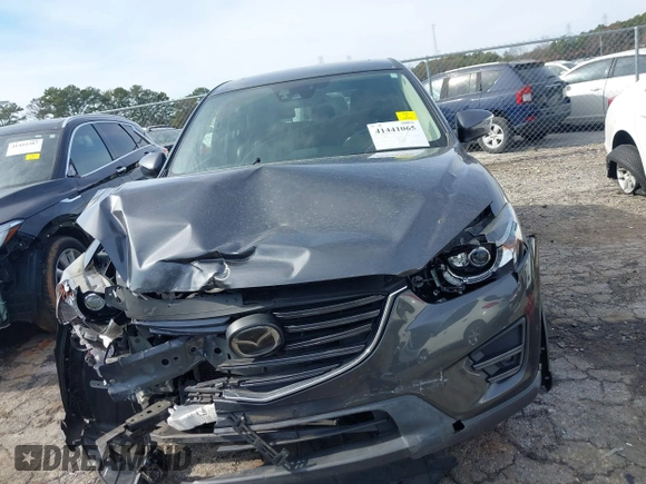 2016 Mazda CX-5 Grand Touring z VIN JM3KE4DY5G0836891, wystawiony jako IAAI lot #41441065 z przebiegiem 120 808 mil mil oraz . Historia ofert i sprzedaży dostępna na DreamBid. Obrazek 12.