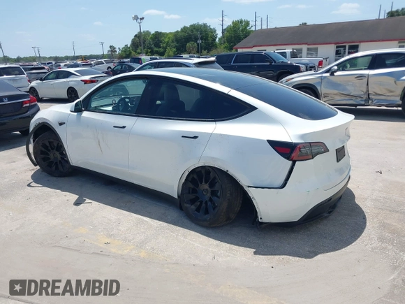 2023 Tesla Model Y Long Range with VIN 7SAYGDEE7PF865539, listed as a IAAI auction lot 42109673 with 34,923 mi miles and . Bid and sale history available at DreamBid. Image 3.