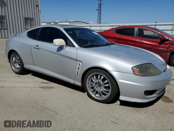 2006 Hyundai Tiburon GT z VIN KMHHN65F26U225506, wystawiony jako Copart lot #56997285 z przebiegiem 170 175 mil mil oraz Szkoda całkowita • Salvage title. Historia ofert i sprzedaży dostępna na DreamBid. Obrazek 4.
