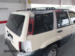 1996 Jeep Grand Cherokee Laredo z VIN 1J4FX58S7TC157272, wystawiony jako IAAI lot #42422023 z przebiegiem 229 170 mil mil oraz . Historia ofert i sprzedaży dostępna na DreamBid. Obrazek 14.