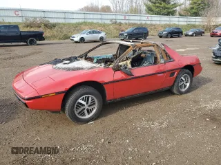 1984 Pontiac Fiero z VIN 1G2AF37R2EP218100, wystawiony jako Copart lot #77358284 z przebiegiem Nie podano mil oraz Czysty tytuł • Clean title. Historia ofert i sprzedaży dostępna na DreamBid. Obrazek 1.