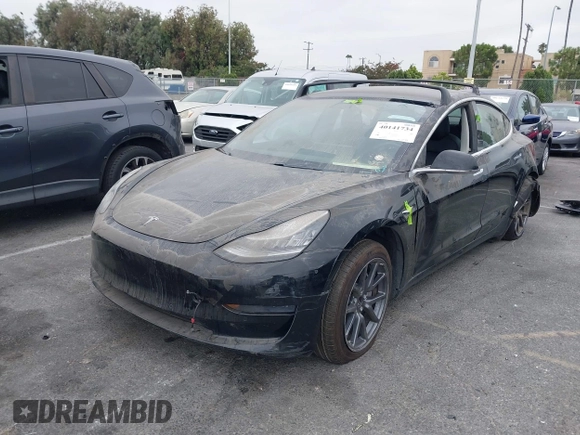 2019 Tesla Model 3 Mid Range with VIN 5YJ3E1EA2KF362048, listed as a IAAI auction lot 40141734 with 70,321 mi miles and . Bid and sale history available at carsss.com. Image 2.