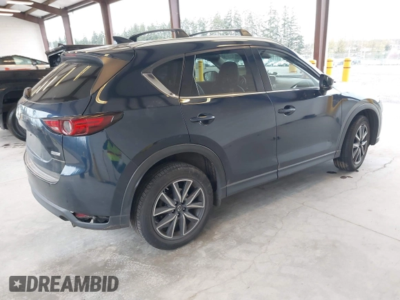 2018 Mazda CX-5 Grand Touring with VIN JM3KFBDM4J0302870, listed as a IAAI auction lot 41934217 with 57,151 mi miles. Bid and sale history available at carsss.com. Image 4.
