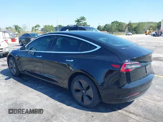 2019 Tesla Model 3 Mid Range with VIN 5YJ3E1EA0KF317058, listed as a IAAI auction lot 42025195 with 108,771 mi miles. Bid and sale history available at carsss.com. Image 3.