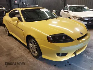 2006 Hyundai Tiburon GT z VIN KMHHN65F56U225936, wystawiony jako IAAI lot #41695280 z przebiegiem 121 110 mil mil oraz . Historia ofert i sprzedaży dostępna na DreamBid. Obrazek 1.