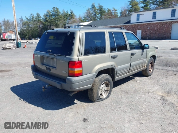 1997 Jeep Grand Cherokee Laredo with VIN 1J4GZ58S7VC713517, listed as a IAAI auction lot 42062214 with 205,533 mi miles. Bid and sale history available at carsss.com. Image 4.