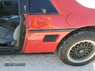 1988 Pontiac Fiero z VIN 1G2PE11R1JP219470, wystawiony jako Copart lot #77772864 z przebiegiem 94 011 mil mil oraz Szkody całkowita. Historia ofert i sprzedaży dostępna na DreamBid. Obrazek 12.