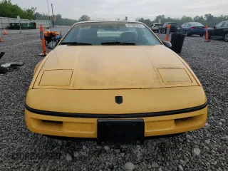 1988 Pontiac Fiero z VIN 1G2PE11R2JP223673, wystawiony jako Copart lot #57300235 z przebiegiem 154 598 mil mil oraz Tytuł czysty. Historia ofert i sprzedaży dostępna na DreamBid. Obrazek 5.