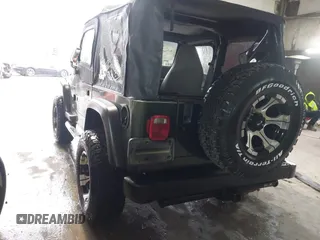 1998 Jeep Wrangler SE with VIN 1J4FY29P2WP733255, listed as a IAAI auction lot 41554602 with 157,316 mi miles. Bid and sale history available at carsss.com. Image 3.