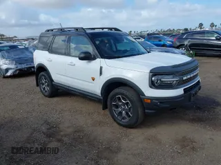 2023 Ford Bronco Sport Badlands z VIN 3FMCR9D90PRD99157, wystawiony jako IAAI lot #41921267 z przebiegiem 26 561 mil mil oraz . Historia ofert i sprzedaży dostępna na DreamBid. Obrazek 1.