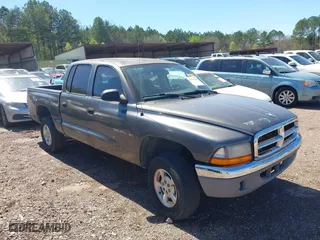 2002 Dodge Dakota SLT with VIN 1B7HG48NX2S623588, listed as a IAAI auction lot 41793068 with 213,159 mi miles. Bid and sale history available at carsss.com. Image 1.