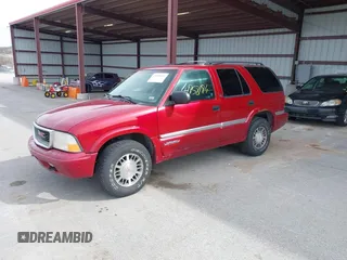 1999 GMC Jimmy SLE with VIN 1GKDT13W3X2504723, listed as a IAAI auction lot 41858184 with 239,227 mi miles. Bid and sale history available at carsss.com. Image 2.