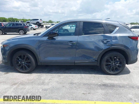 2024 Mazda CX-5 S Carbon Edition z VIN JM3KFBCLXR0521353, wystawiony jako IAAI lot #42351444 z przebiegiem 17 270 mil mil oraz . Historia ofert i sprzedaży dostępna na DreamBid. Obrazek 14.