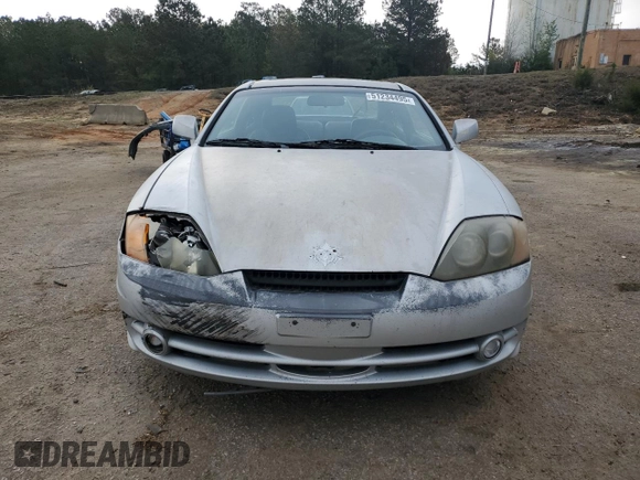 2003 Hyundai Tiburon GT z VIN KMHHN65F13U013420, wystawiony jako Copart lot #51234495 z przebiegiem 230 612 mil mil oraz Szkoda całkowita • Salvage title. Historia ofert i sprzedaży dostępna na DreamBid. Obrazek 5.